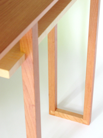 This cherry and maple hall table features a unique joinery detail of dovetail feet- they add stability to the narrow table design but are a beautiful display of fine craftsmanship as well.