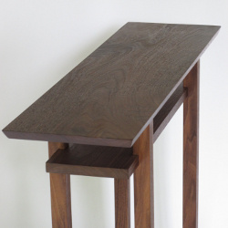 Mokuzai Furniture's Classic Tables are available in walnut. The dark brown wood color works with many interior design schemes and the minimalist furniture design lines look elegant in this selection