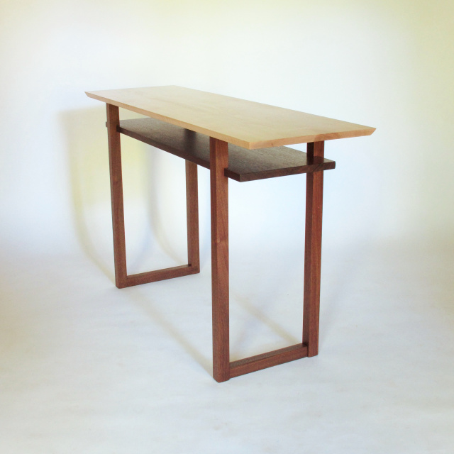 A narrow minimalist wood sideboard table for a small dining room.  Pictured in tiger maple with walnut this solid wood console table is handmade and can be customized