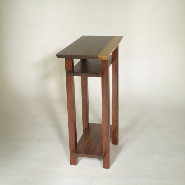 a narrow table with live edge table top. Handmade from solid walnut, this small end table is great for tight spaces. The live edge table top is unique.