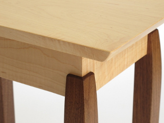 Our hand-cut joinery at the connection of these table legs, is highlighted by the contrasting wood colors of the tiger maple and walnut