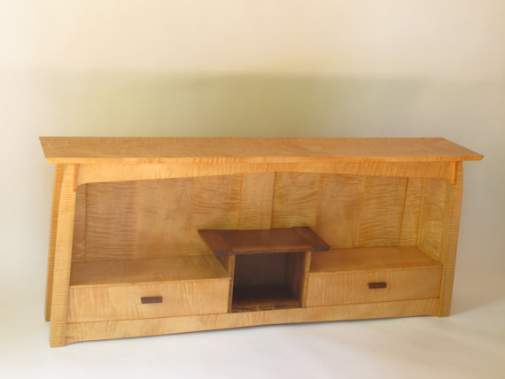 A solid wood modern sofa console cabinet created here in tiger maple with walnut accents- wonderful for display and storage solutions- an artistic bookcase and console table for behind the sofa