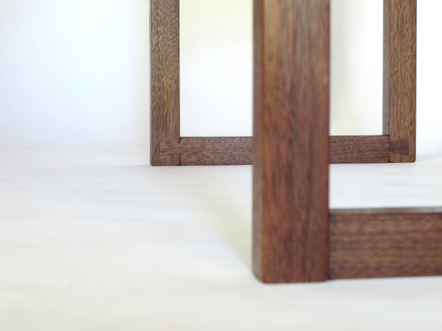 These walnut table legs feature hand-cut dovetail feet.  Left visible, our fine hand-cut joinery shows off the quality of our handmade tables.