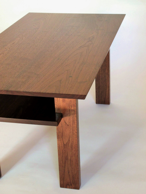 A handmade narrow wood coffee table with inset shelf for storing remotes, magazines and more