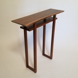 Our Classic Side Table in live edge walnut.  A dark brown wood tone with a natural edge table top for a one-of-a-kind custom work of art
