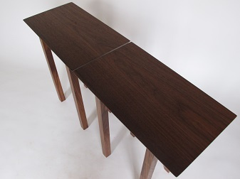 This pair of walnut end tables with table tops that are cut from the same walnut slab