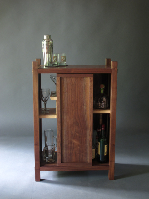 bar cabinet with door, liquor cabinet, alternating shelving for display and glassware
