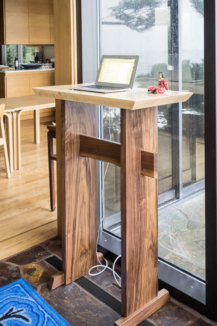 A modern wood stand up desk- this standing desk is made from tiger maple and constrasting walnut and with fine handmade details, this minimalist desk will be inspirational in your home office.