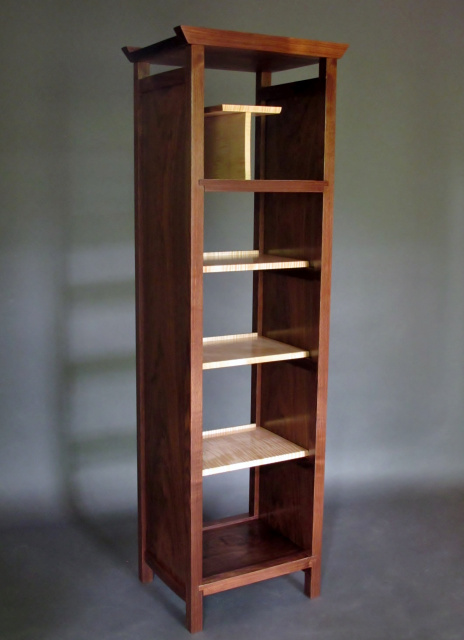 A tall narrow cabinet with open shelving for a media tower or artistic bookcase