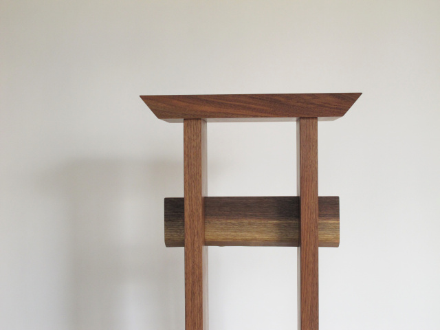 A minimalist entry table made from solid walnut. Japanese furniture styling with modern design lines